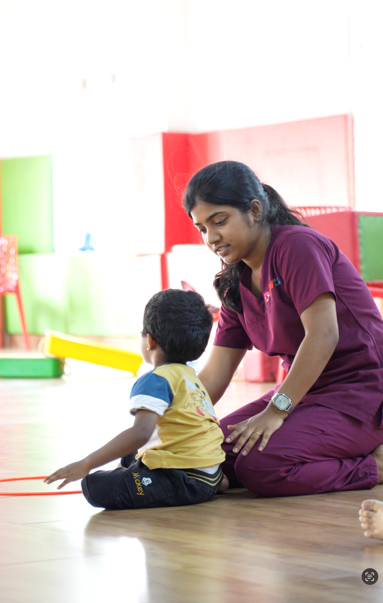 Child receiving occupational therapy support during a developmental intervention session.